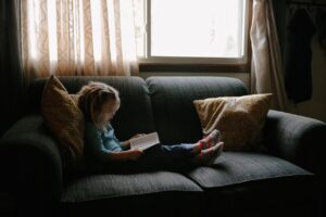 kid, people, girl, child, sitting, couch, pillow, reading, book, bible, window, glass, curtain, inside, bible, bible, bible, bible, bible